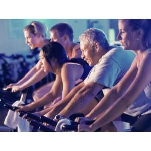  Group of People on Exercise Bikes in a Health Club Premium 