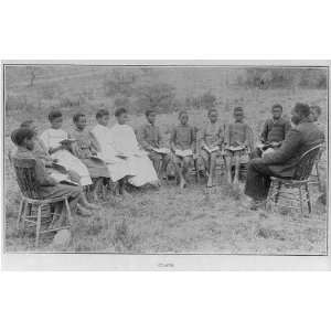   American children in outdoor class,seated in chairs in a circle,Negros