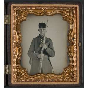   in uniform with Company H hat holding bayoneted musket