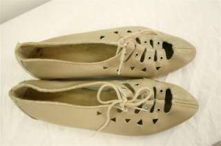 Vintage tan lace up flat shoes with triangle cut outs. Some very light 