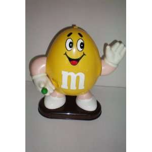 HTF    Yellow M & M Candy Dispenser    M&M Candy is Dispensed When 