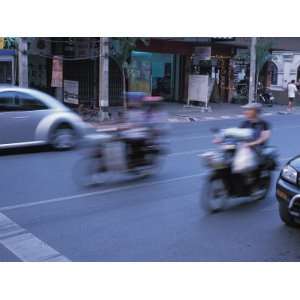 Blurred Motion of Cars and Motorcycles on Busy City Street Stretched 
