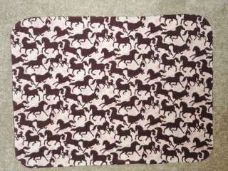 The theme for this crib sheet set   Running brown horses on a pink 