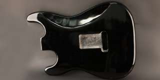 This is a strat body finished in gloss black, prerouted to fit all of 