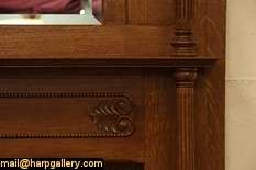 An authentic Victorian fireplace mantel and surround has a beveled 